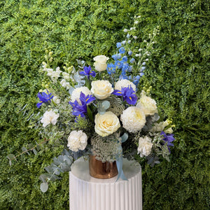 Bouquet of flowers in a vase against a green leafy background