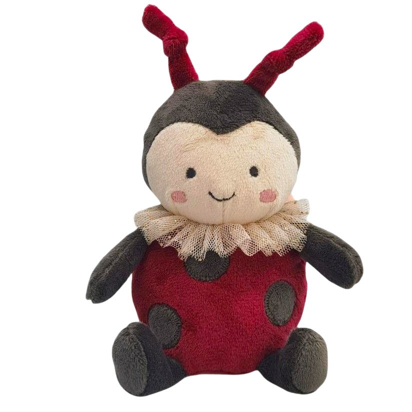 Stuffed ladybug toy with a smiling face on a white background